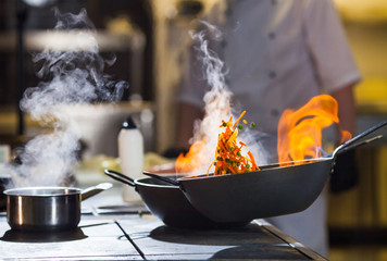 cook making dinner in the kitchen of high-end restaurant.