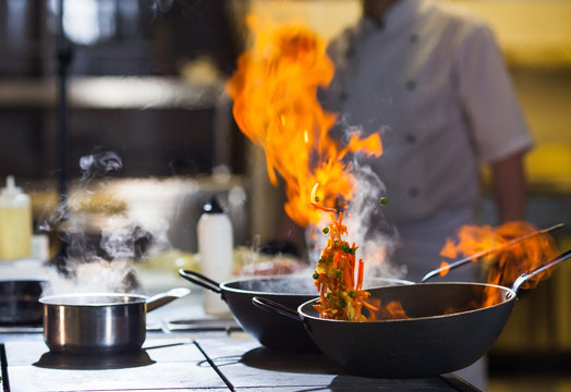 cook making dinner in the kitchen of high-end restaurant.