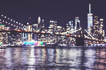 Blurred New York City skyline at night, color toned urban background, USA.