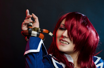 beautiful portrait red-hair girl with king snake.