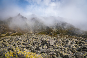Fototapeta na wymiar Foggy Poprad Ridge with Rocks in Foreground in High Tatras Mountains, Slovakia