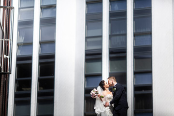 Bride and groom walking in the city, wedding day, marriage concept. Bride and groom in urban...