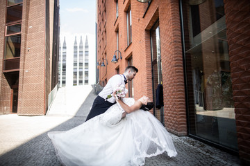 Bride and groom walking in the city, wedding day, marriage concept. Bride and groom in urban...