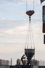 construction workers at a construction site pouring concrete