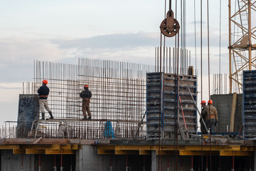 construction workers fix steel bars at a construction site