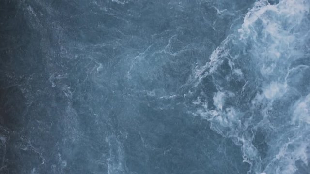 Frozen river landscape in iceland in aerial view. Blue water texture. Slow motion