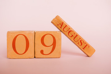 august 9th. Day 9 of month, handmade wood calendar  on modern color background. summer month, day of the year concept