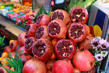 Orange, grapefruit, pomegranate sliced. fruit background. Ripe juicy pomegranates, tangerines and oranges are sold on the counter of a fruit shop on Istanbul street.