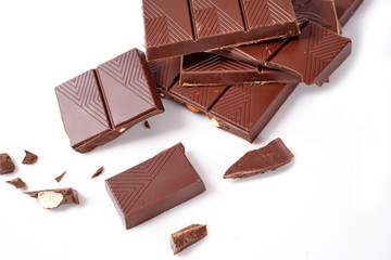 Chocolate pieces with almonds on white background