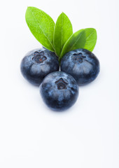 Fresh raw organic blueberries with leaf on white background. Macro close up