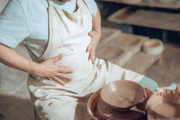 High angle of Caucasian craftsman working in potter's studio