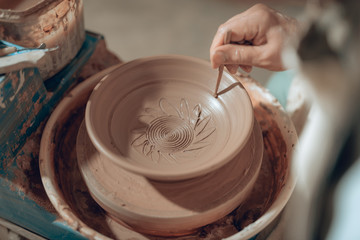 Close up of male arms with stick over ceramic plate