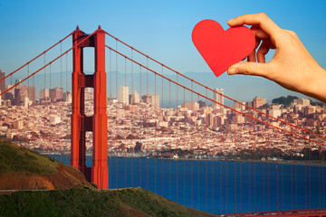 Hold red heart, golden gate bridge San Francisco