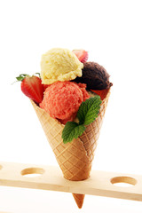 Set of ice cream scoops of different colors and flavours with berries and fruits
