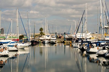Fototapeta na wymiar Landscape of a marina in Cyprus with cloudy sky and water reflections 
