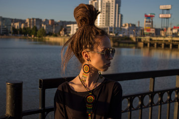 Fototapeta na wymiar dreadlock girl with dreads and rastaman earrings