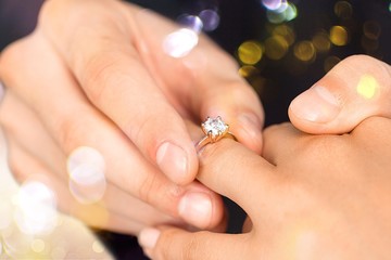 Close up Groom Putting the Wedding Ring on bride