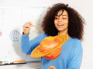Female student with curly hair talk about Saturn
