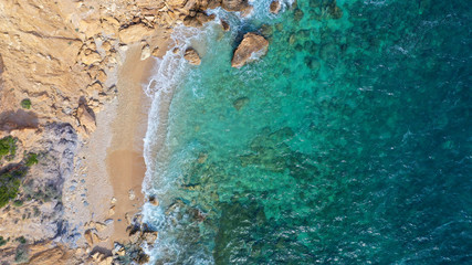 Aerial top view photo of tropical paradise deep emerald sea mediterranean sandy beach with strong waves