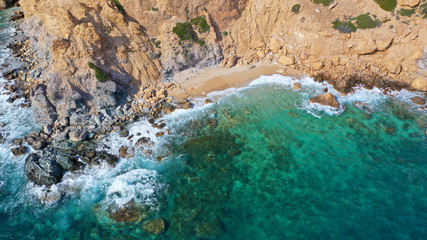 Fototapeta na wymiar Aerial drone bird's eye view of famous emerald sea rocky beach of KAPE in area of Legrena, Sounio, Attica, Greece