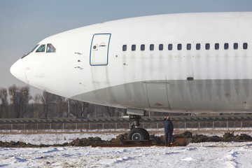 Close up of old unused large passenger plane on a snowy field, will be turned into a museum piece. Decommissioned aircraft. 
