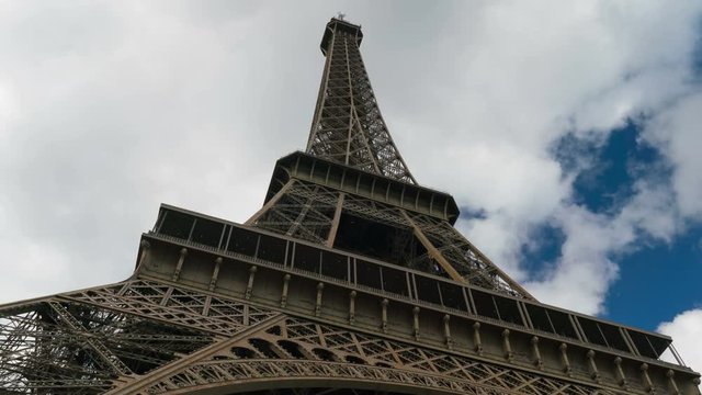 Eiffel tower blue sky with clouds down to top view hyperlapse