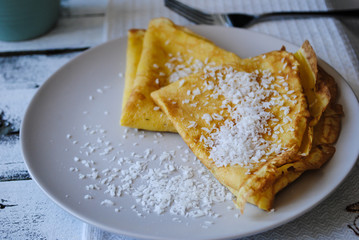 Pancakes sprinkled with coconut chips.