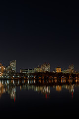 illuminated buildings with reflection on water at night