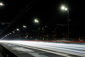 long exposure of lights on road at nighttime near buildings