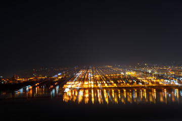 Fototapeta na wymiar aerial view of dark cityscape with illuminated buildings at night