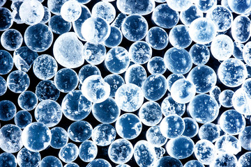 Blue crystal spherical balls pattern. Abstract round bubbles glowing magicly.