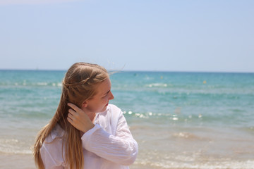 Fototapeta na wymiar Pretty blonde woman posing on the beach