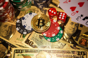 Colorful casino chips, dollars, bitcoins and red dice