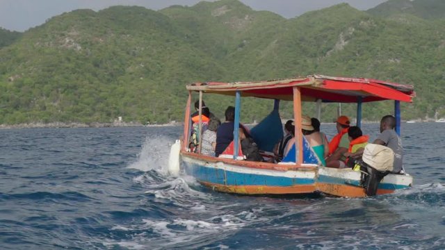 Slow Motion: Rear Shot of Water Taxi Pitching Over Small Ocean Waves in Chouchou Bay, Haiti
