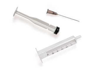 Disassembled medical syringe with needle. 6 ml disposable syringe close up, isolated on white background, with shadows.