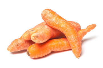 closeup of deformed carrots on white background
