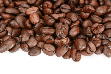 Roasted coffee beans, dark brown close up, isolated on a white background
