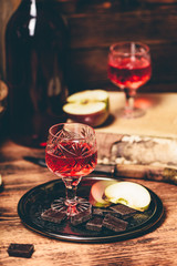 Homemade red currant nalivka and chocolate with apple
