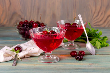Jelly from a sweet cherry on a wooden background