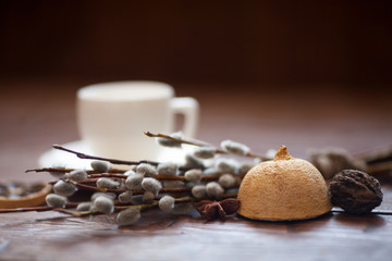 Fototapeta na wymiar Coffee cup and willow branches, dry lemon, cinnamon.
