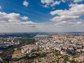 landscape view over city on summer sunny day with clouds aerial and view to lake