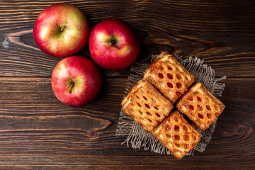 Puff pastry with apple on dark wooden background.