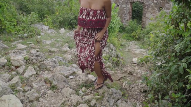Busty Woman Steps Up on Ancient Stones with Tropical Background in Citadel Laferriere, Haiti