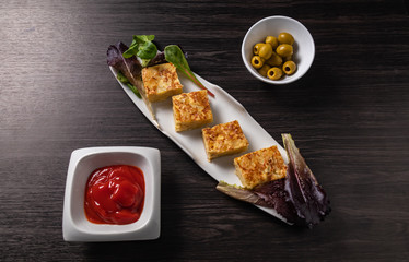 Spanish tapa, omelette, olives and sauce