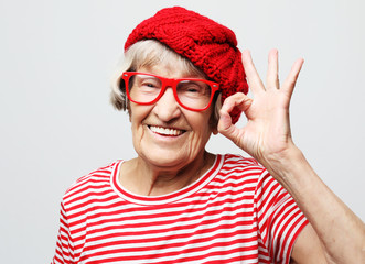 Lifestyle, emotion and people concept: Elderly happy woman showing ok