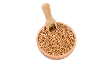 roasted buckwheat in wooden bowl and scoop isolated on white background. nutrition. bio. natural food ingredient.