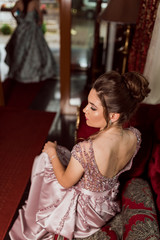 Young beautiful girl in pink luxury dress for the prom night