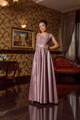 Fototapeta premium Young beautiful girl in pink luxury dress for the prom night