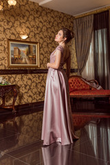 Fototapeta premium Young beautiful girl in pink luxury dress for the prom night