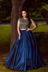 Beautiful young lady in luxury blue dress for her prom night